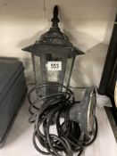 A carriage lantern style wall lamp with cable and plug