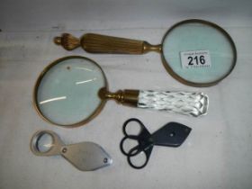 Two 20th century magnifying glasses and two others.