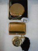 An Estee Lauder compact, a Stratton compact and a Melissa compact.