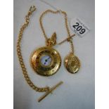 A gold coloured half hunter pocket watch with chain.