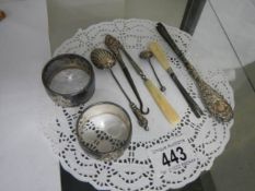 Two silver napkin rings, silver handled button hook and three other items of silver.