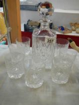 A cut glass decanter and glasses.