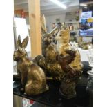 A mixed lot of rabbit and cat figures.