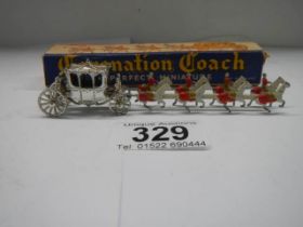 A boxed miniature coronation coach, in good condition.