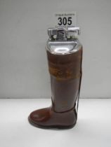 An unusual cigarette lighter in the form of a leather boot.