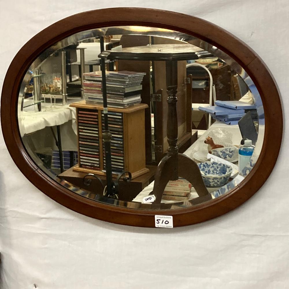 An oval mahogany bevelled mirror 45cm x 60cm