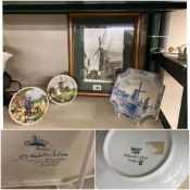 A vintage windmill framed picture, a Delft plate and two others