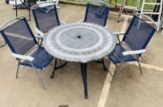 A large circular metal garden table with tile effect finish to the top of the table. Complete with 4