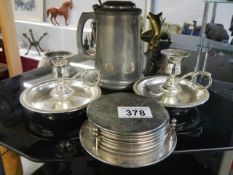 A pair of silver plate candlesticks, set of coasters and a tankard.