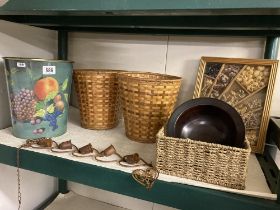 A collection of baskets, wooden bowl metal chime and rustic picture
