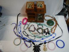 An jewellery box with a mixed lot of costume jewellery.