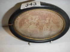 A framed oval engraving (crack to frame).