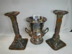 A pair of early 20th century plated candlesticks and a twin handled urn.