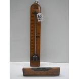 A vintage thermometer and spirit level.