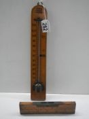 A vintage thermometer and spirit level.