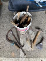 A bucket including cement, plaster floats & other tools