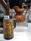 A decorative ceramic jug and a beer stein.