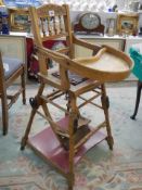 An early to mid 20th century metamorphic child's high chair. COLLECT ONLY.