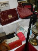 A mixed lot of vintage hand bags and clutch bags.