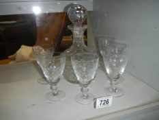 A cut glass decanter and six glasses.