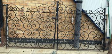 A pair of wrought iron gates & posts Height 133cm x Width 260cm