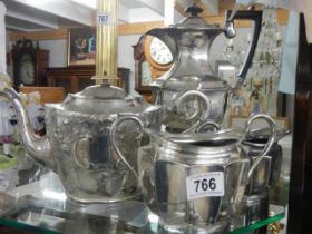 A silver plate tea pot, hot water jug, milk jug and sugar bowl.