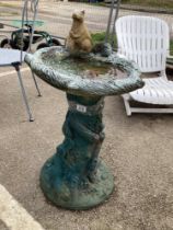 A heavy bird bath with squirrel