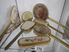 A mixed lot of hand mirrors and hair brushes.
