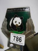 A World Wild Life Fund car badge.