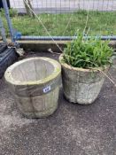 A pair of round concrete planters