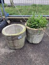 A pair of round concrete planters