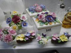 A quantity of porcelain posies and trinket boxes.
