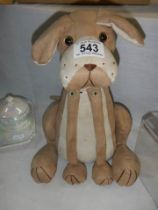 A fabric dog doorstop.