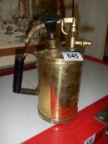 A brass spray gun.