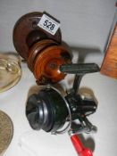 Two wooden fishing reels and one other.
