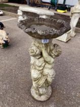 A Bird bath with Cherubs on stand