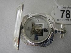 An unusual square shaped pocket watch.