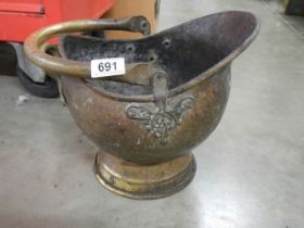 A copper coal scuttle.