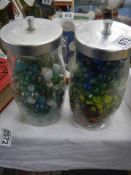 Two jars of old marbles.