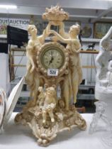 A classical design clock with figures on either side and a cherub in front.