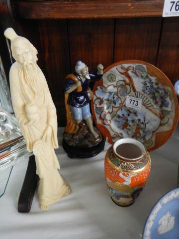 An oriental plate, vase and two figures.