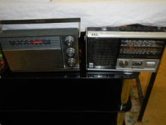 Two vintage portable radios.