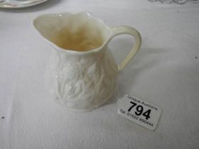 A Belleek cream jug.