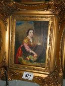 A gilt framed study of a lady with fruit basket.