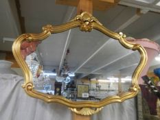 A decorative gilt framed mirror. COLLECT ONLY.