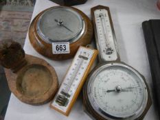 Two barometers, two thermometers and a carved owl dish.