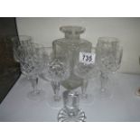 A cut glass decanter with six glasses.