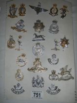 A quantity of replica military cap badges.