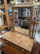 A pine dressing table with mirror and drawers