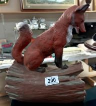 A ceramic fox on log (Waiting to pounce) Signed Yozie c89 Height 28cm, Width 20cm, Depth 14cm